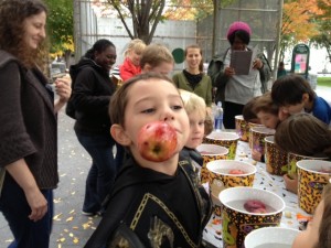child bobbing for apples