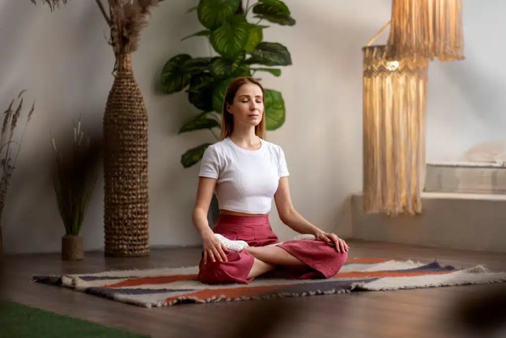 woman meditating in home wellness space