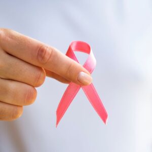 person holding breast cancer awareness ribbon