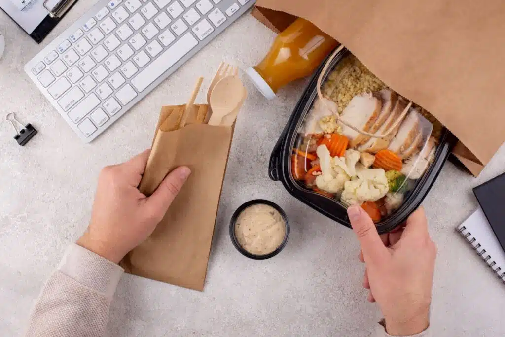 hands taking meal prep lunch box out of bag
