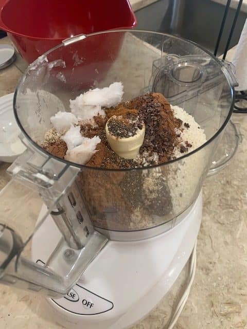 food processor with cocoa date ball ingredients