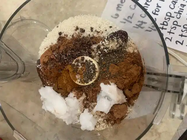 food processor with cocoa date ball ingredients