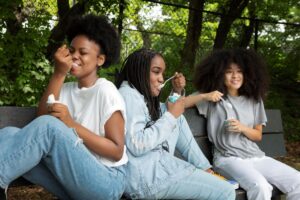 happy teen girls eating ice cream together