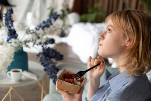 woman thoughtfully eating