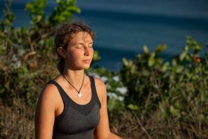 woman doing breathing exercises outside