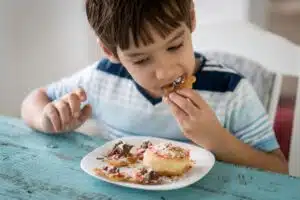 child eating desserts