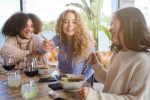 friends eating ramen and drinking wine together