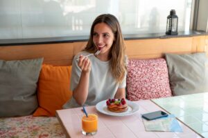 woman intuitively eating pancakes for breakfast