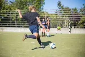 soccer player with optimal nutrition kicking ball