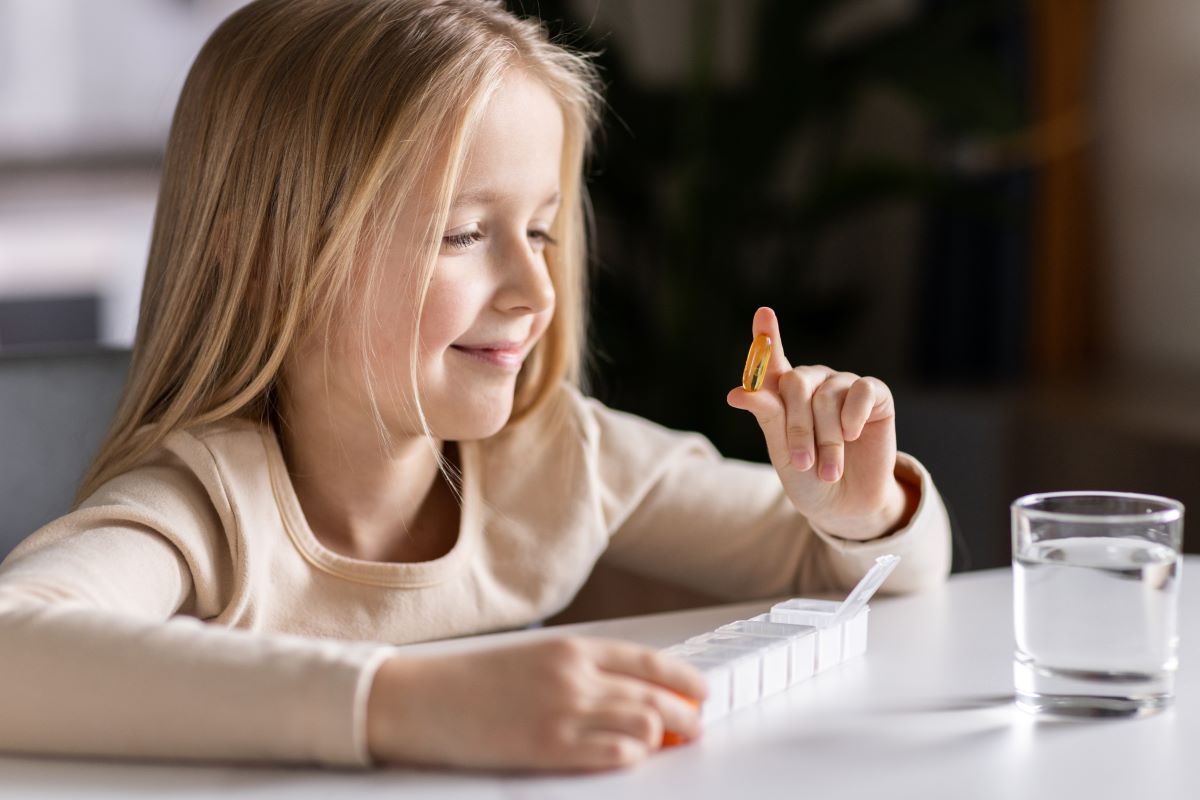 child taking vitamins