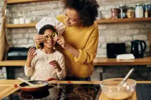 mother teaching daughter how to cook with a healthy relationship to food
