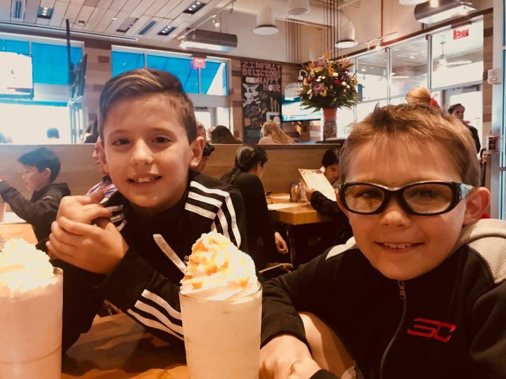 laura cipullo's kids eating milkshakes at a restaurant