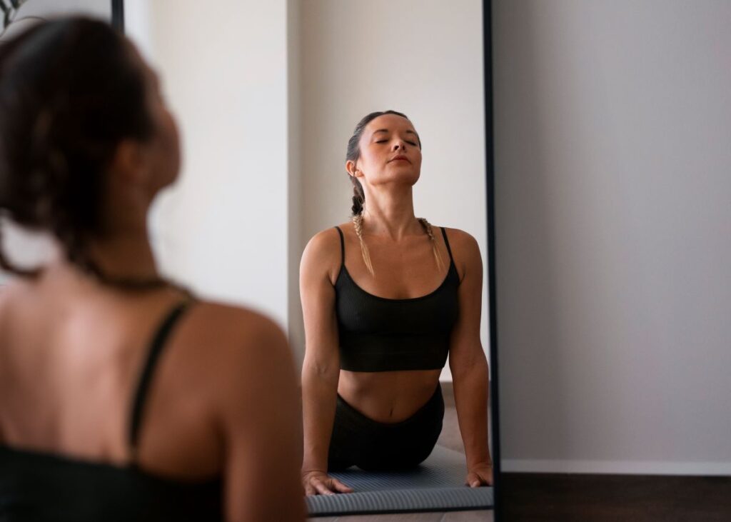 woman exercising in front of mirror