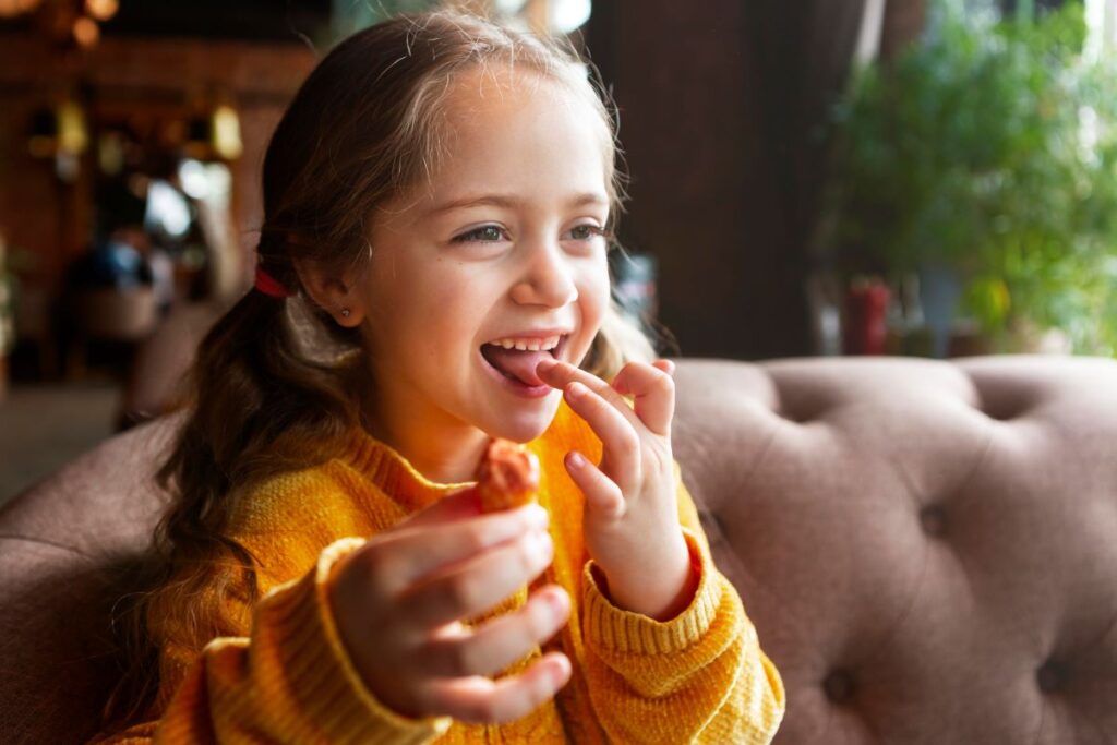 child smiling while eating