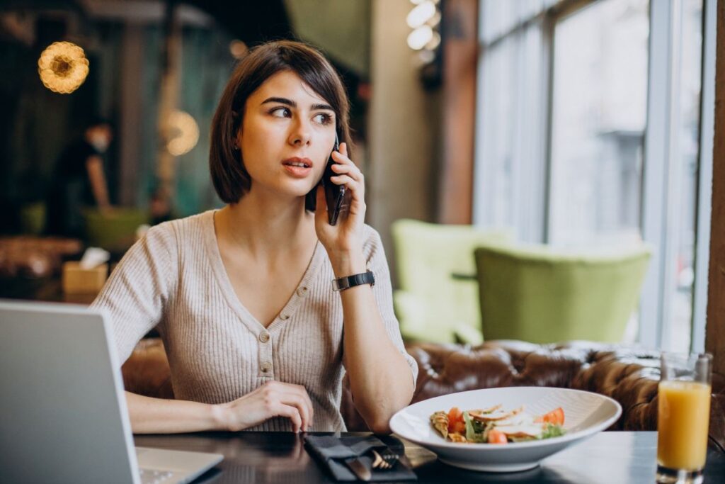 woman on a call at lunch looking concerned