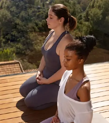 two women meditating together