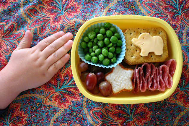 child's hand with lunch box