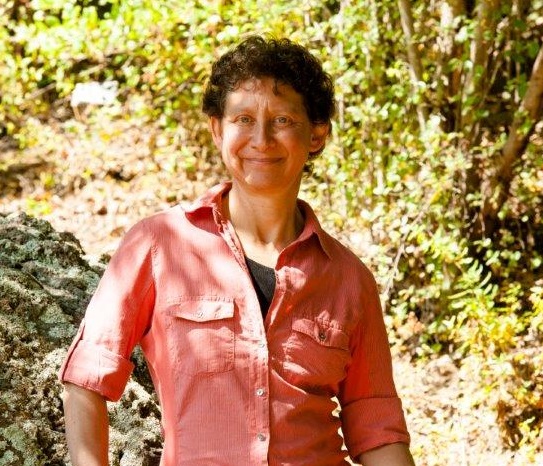 Linda Bacon smiling in forest