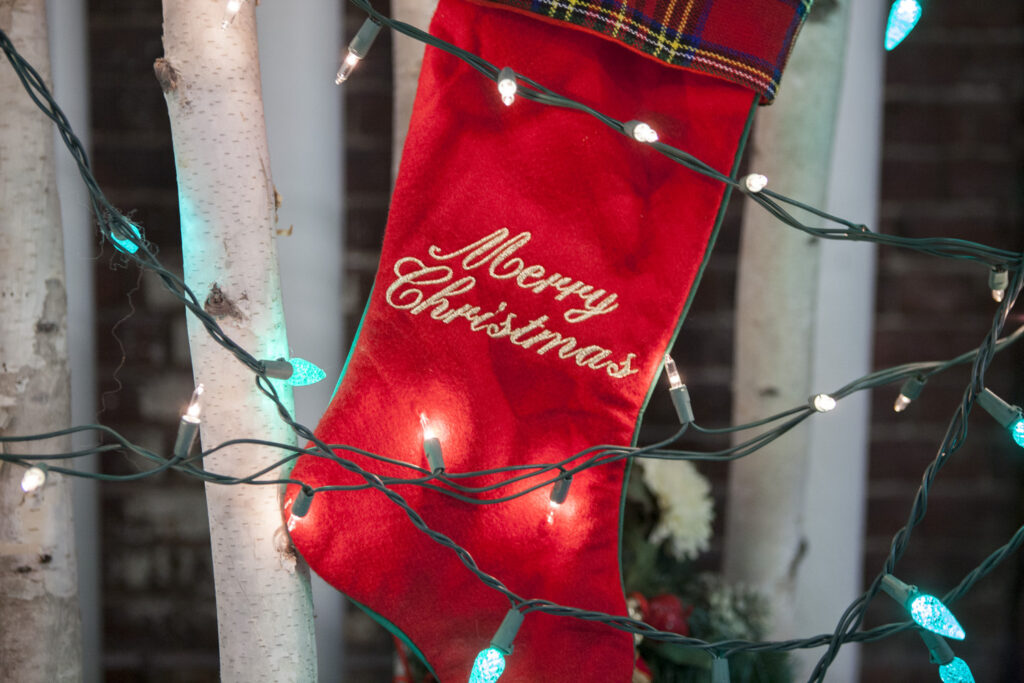 christmas stocking with the words merry christmas and holiday lights