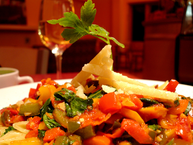 plate of pasta with vegetables and herbs