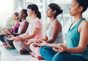 women mediating together in a class