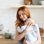 mother holding baby in kitchen