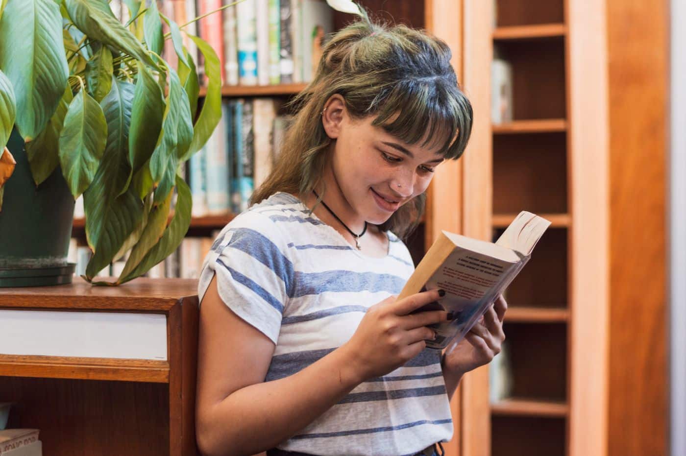 teen girl reading body positive book about nutrition and metabolism