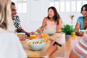 Group of friends happily sharing a meal